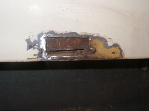 1990 Ford Bronco - Bottom right almost in the corner. I cut out a small hole about 2 in long by 1 in tall. I see lots of rust. I think I will have to cut most…