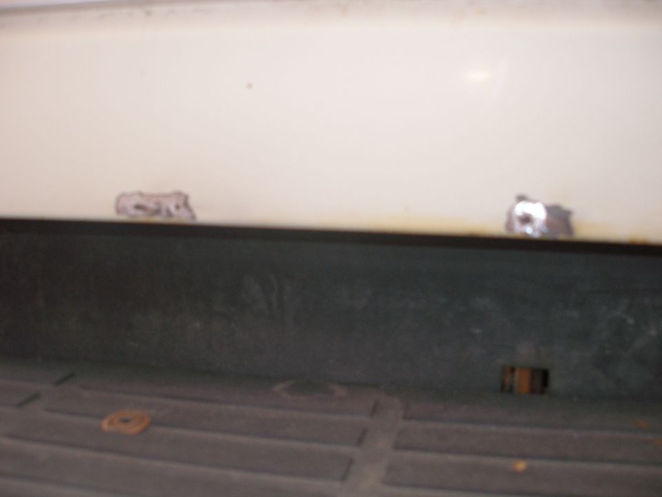 Underside view of a body panel above a truck bed liner