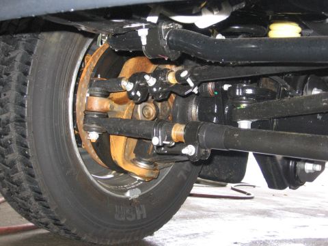 1974 Ford F-100 - The intricate network of steering and suspension parts on a truck's front end is shown in this detailed view.
