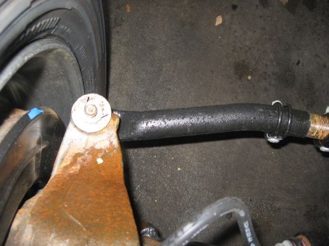 1974 Ford F-100 - Detail of a vehicle's steering linkage and tire, with visible text from Supermotors.net.