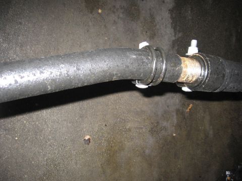 1974 Ford F-100 - Close-up of an exhaust pipe joint secured by clamps and bolts.