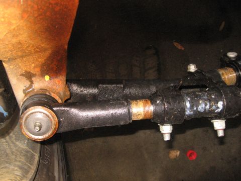1974 Ford F-100 - This image shows a close-up view of a vehicle's steering linkage components, including a tie rod end and drag link.
