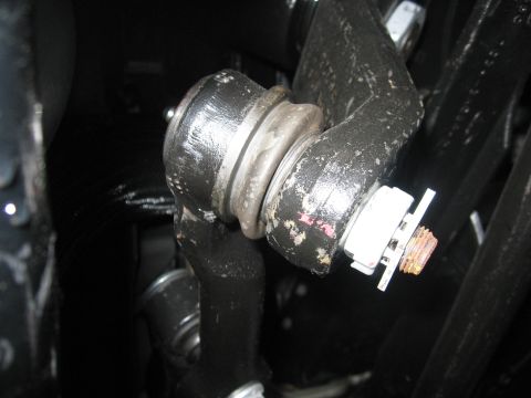 1974 Ford F-100 - Detail of a vehicle's steering linkage, showing a ball joint and securing hardware.