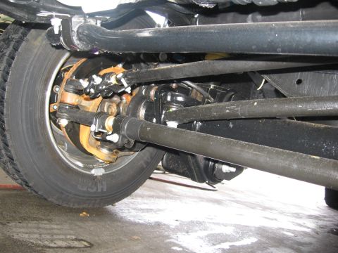 1974 Ford F-100 - Underside view of a vehicle's front wheel, steering, and suspension system.