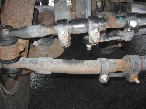 1974 Ford F-100 - Close-up view of a truck's steering linkage components, including tie rods and ball joints.