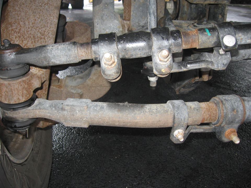 Close-up of truck steering linkage with tie rods and ball joints
