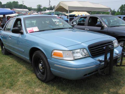 1991 Ford LTD Crown Victoria - A light blue sedan is parked on grass with a dark sedan behind it.