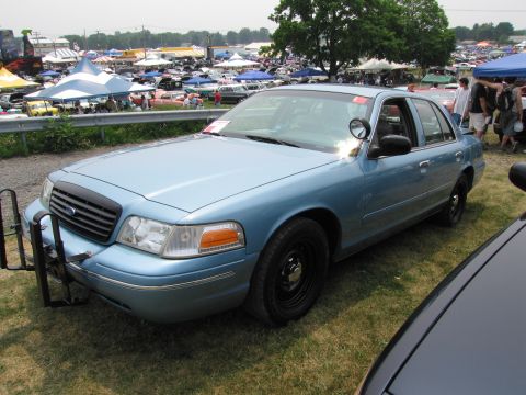 1991 Ford LTD Crown Victoria - A light blue 1991 Ford Crown Victoria LTD, equipped with a push bar, is displayed at an outdoor car show.