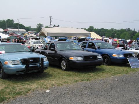1991 Ford LTD Crown Victoria - Multiple Ford Crown Victoria Police Interceptors are displayed at an outdoor event.