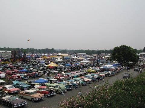 1991 Ford LTD Crown Victoria - A large outdoor car show features numerous classic vehicles parked in rows, with tents and spectators visible.