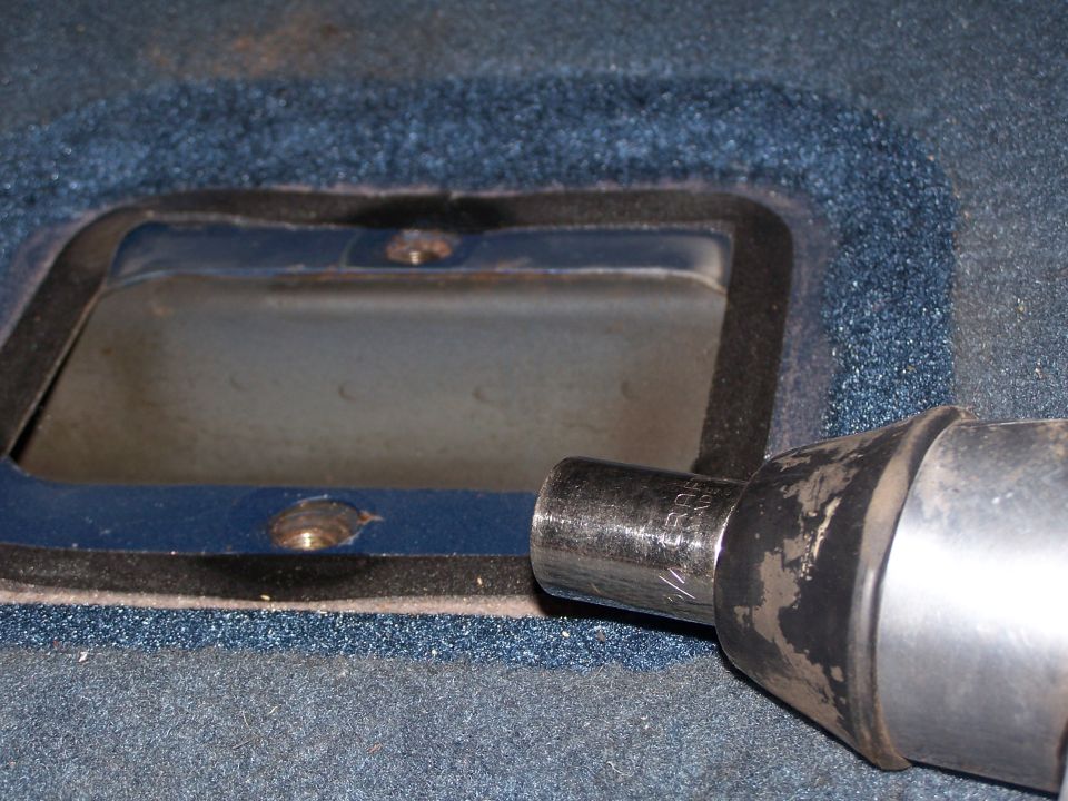 Carpeted access panel opening with a socket extension tool