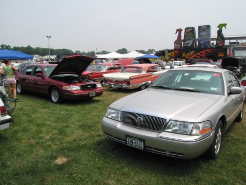 1991 Ford LTD Crown Victoria - Silver Mercury Grand Marquis and red Ford Crown Victoria at a car show event.