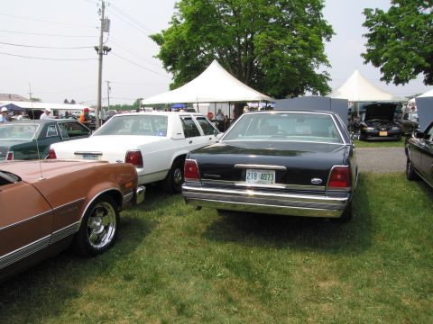 1991 Ford LTD Crown Victoria - This black 1991 Ford Crown Victoria LTD is seen from the rear at an outdoor car show.