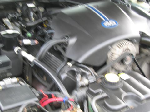 1991 Ford LTD Crown Victoria - Close-up view of a car's engine bay, showing various components and wiring.