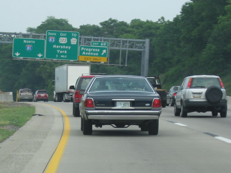 Rear view of a black 1991 Ford Crown Victoria LTD on a highway