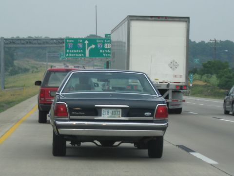 1991 Ford LTD Crown Victoria - Rear view of a 1991 Ford Crown Victoria LTD driving on a highway.