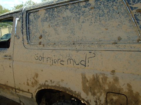 1991 Ford Bronco - This mud-splattered SUV has a humorous message scrawled on its side, asking "Got more mud?"