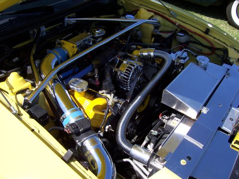 2002 Ford Mustang - Customized engine bay chrome and yellow accents, likely a performance modification.