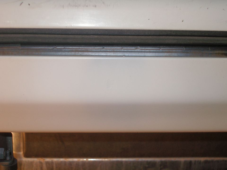 Sanded, primed, and painted. Its hard to find 1990 model ford faded white. I got an artic white from duplicolor. I dont like this because there is a small dimple created when I sanded the rust out. This lead to me getting some bondo as filler.