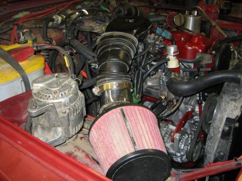 1987 Suzuki Samurai - Close-up view of a vehicle's engine bay, showing various components and wiring.