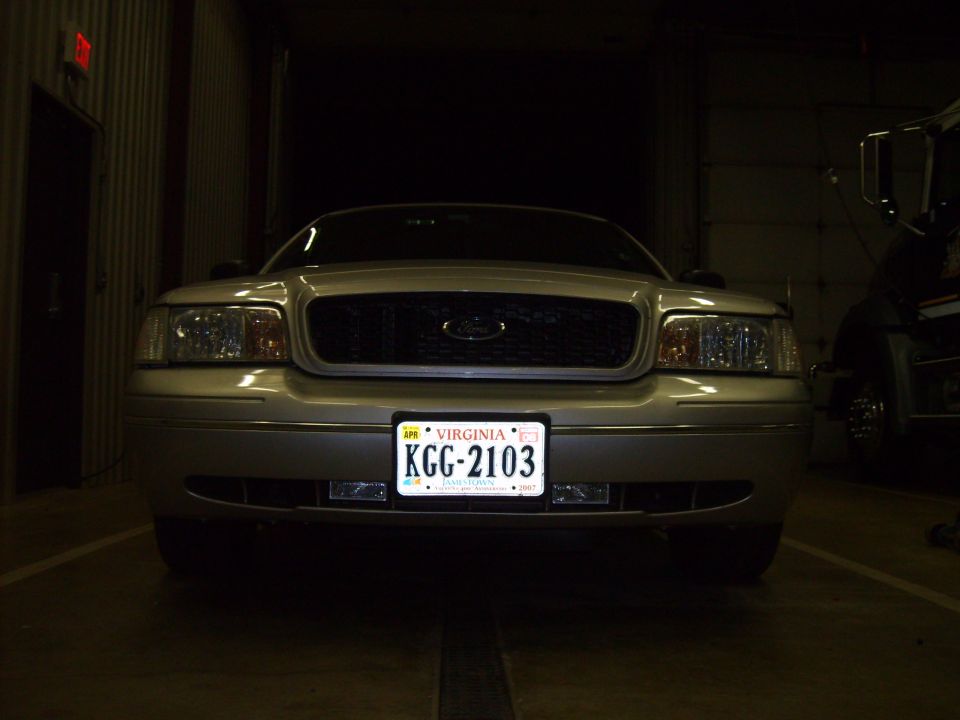 Front of silver Ford Crown Victoria with Virginia plate KGG-2103 in a garage