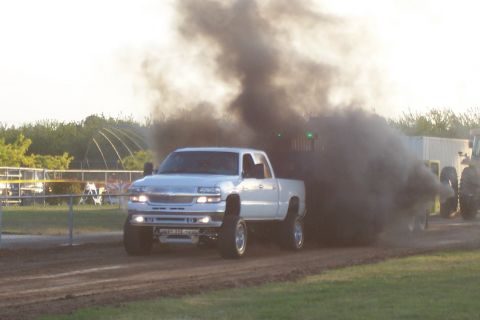 1994 Ford F-150 - A pickup truck is seen pulling a trailer while emitting a large cloud of black smoke.