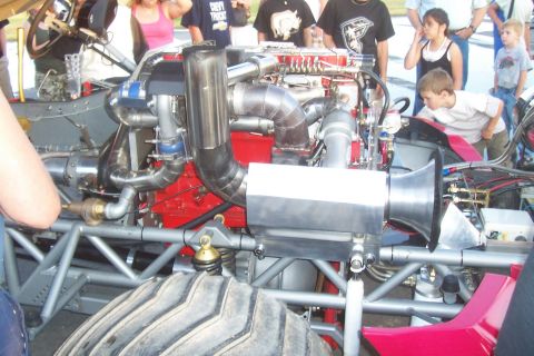 1994 Ford F-150 - Close-up of a highly modified engine, likely for a monster truck or drag racing vehicle.