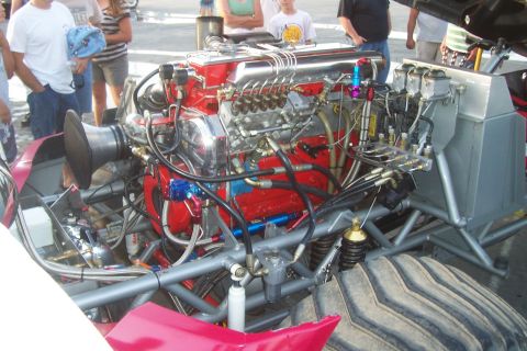 1994 Ford F-150 - Close-up of a powerful custom engine with intricate plumbing and a large air intake.