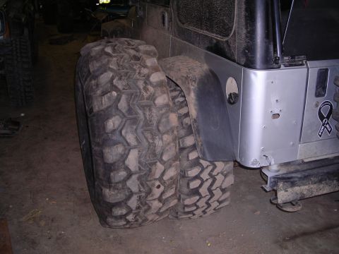 2003 Jeep TJ - A close-up shot of a Jeep TJ's rear tire and fender, a POW MIA ribbon sticker on the body panel.
