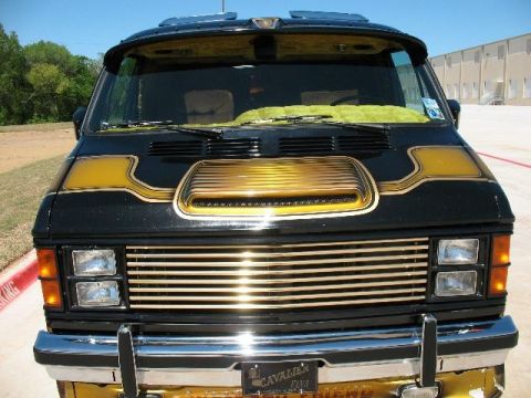 1978 Ford E250 - This van has a custom gold grille and hood scoop, with "CAVALIER" and "FRIEND" visible on the bumper.