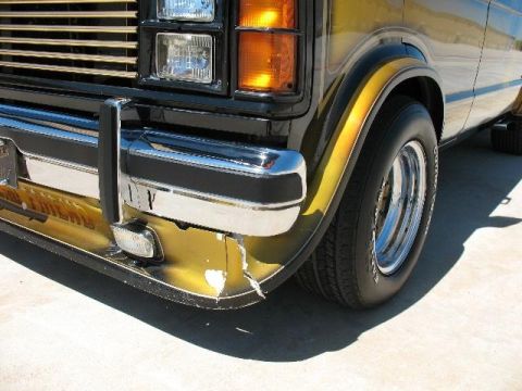 1978 Ford E250 - Front corner of a 1978 Ford E250 van, showing chrome bumper and custom gold paint.