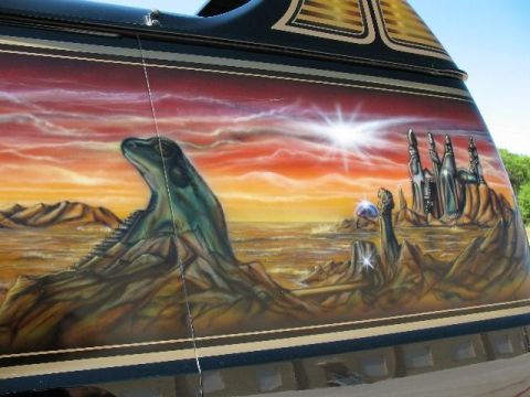 1978 Ford E250 - Custom airbrushed side panel depicts an alien landscape with a prominent creature and futuristic city under a dramatic sky.