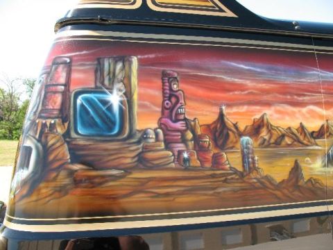 1978 Ford E250 - Custom airbrushed mural on a van depicts a desert scene with a tiki idol and strange rock formations.