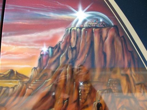 1978 Ford E250 - This airbrushed mural shows a fantastical scene with a city enclosed in a dome on top of a mountain.