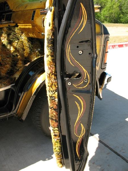1978 Ford E250 - The interior of this van features custom fuzzy upholstery and pinstripes on the door.