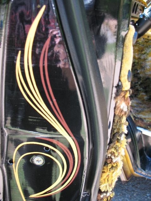 1978 Ford E250 - Close-up view of the interior door panel of a van, custom pinstriping and plush trim.
