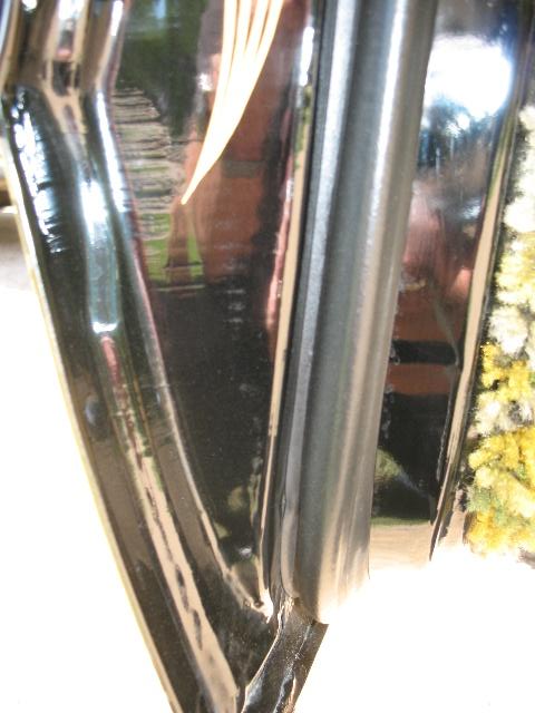 1978 Ford E250 - A detailed view of the door jamb and seal on a vehicle, with reflections visible on the glossy surface.