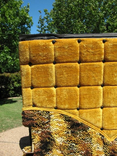 1978 Ford E250 - Close-up of vintage interior upholstery and carpet, set against a backdrop of trees and blue sky.