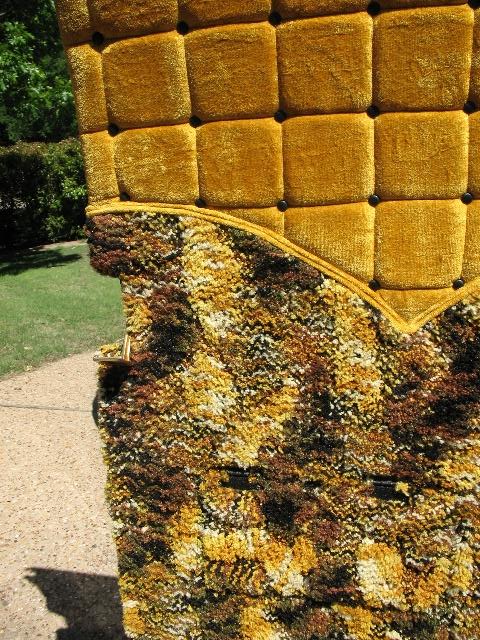 1978 Ford E250 - Close-up of yellow tufted upholstery with a multi-colored patterned fabric trim, likely from a vehicle interior.