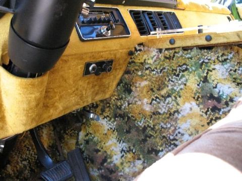 1978 Ford E250 - The van's interior features a yellow fuzzy dashboard and a colorful floral carpet on the floor.
