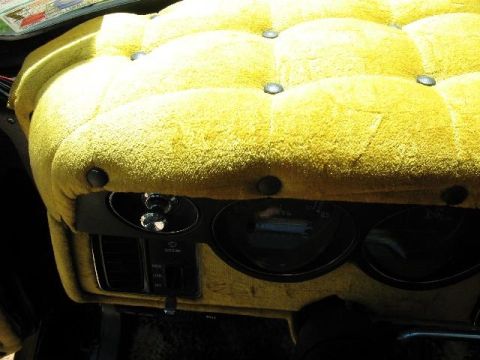 1978 Ford E250 - Interior view of a 1978 Ford E250 van, a distinctive yellow tufted dashboard and instrumentation.