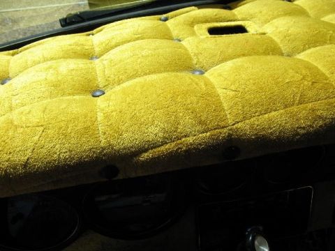 1978 Ford E250 - Interior view of a custom tufted yellow dashboard with visible vents and buttons.