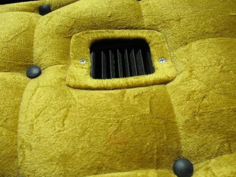 1978 Ford E250 - The interior of the vehicle features plush yellow upholstery and a black air vent.