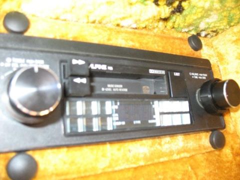 1978 Ford E250 - Close-up of an Alpine car stereo unit, a CD player and prominent control knobs.