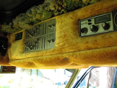 1978 Ford E250 - The van's interior features custom yellow shag carpeting and aftermarket audio equipment, including a Sanyo equalizer and a Tram CB radio.