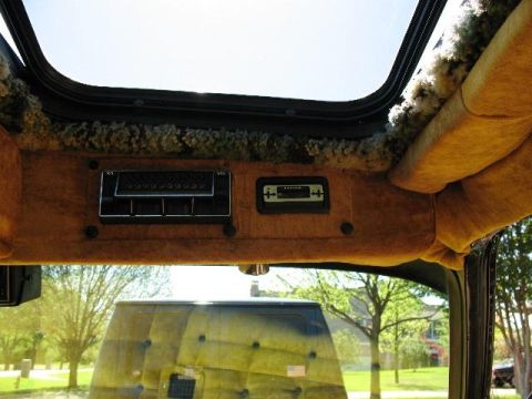 1978 Ford E250 - Van interior shows a control panel and sunroof, with an exterior reflection in the windshield.