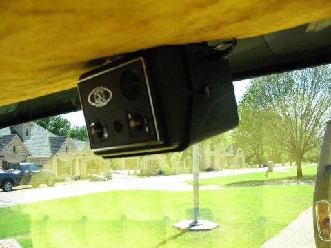 1978 Ford E250 - View from inside a vehicle shows a mounted electronic device and a residential street scene.