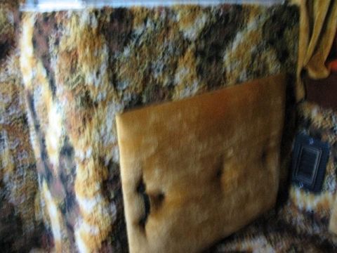 1978 Ford E250 - The interior of a van features a distinctive fuzzy patterned upholstery and a velour seat cushion.
