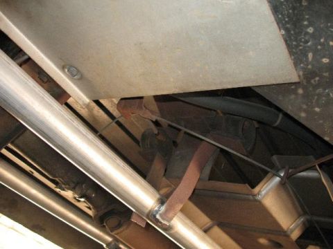 1978 Ford E250 - Undercarriage view reveals exhaust pipes and structural elements with signs of wear and repair.