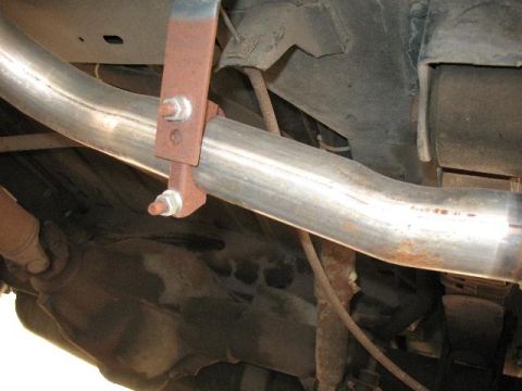 1978 Ford E250 - Close-up of a vehicle's undercarriage, showing the exhaust system and rear differential.